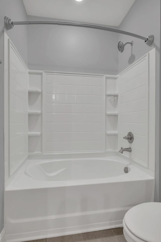 bathroom featuring tile patterned floors, toilet, and shower / bath combination