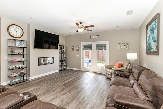 living room with ceiling fan and hardwood / wood-style floors