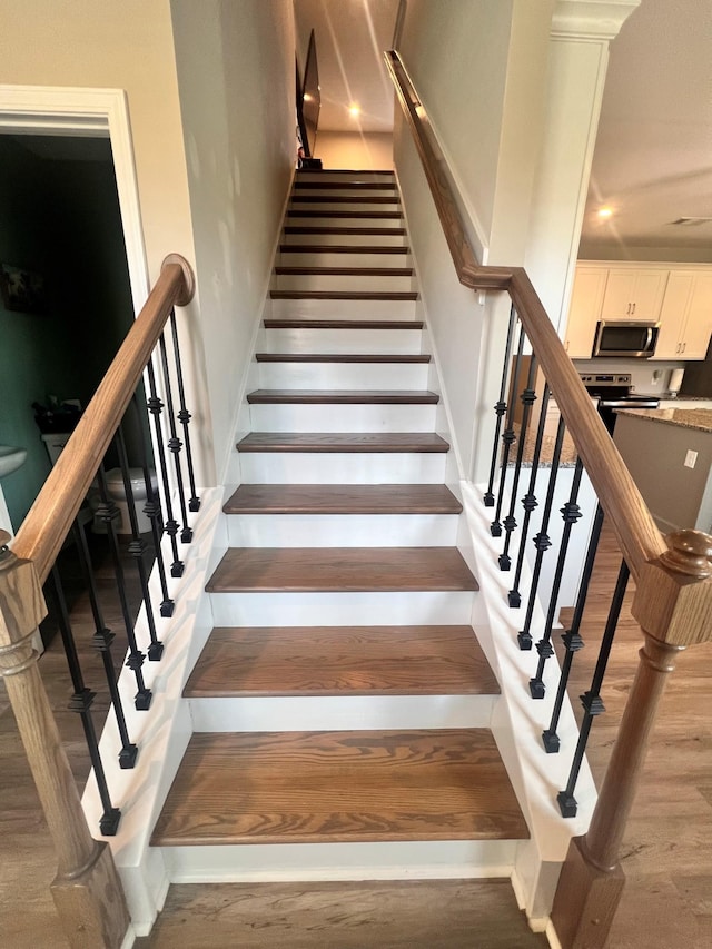 staircase featuring hardwood / wood-style floors