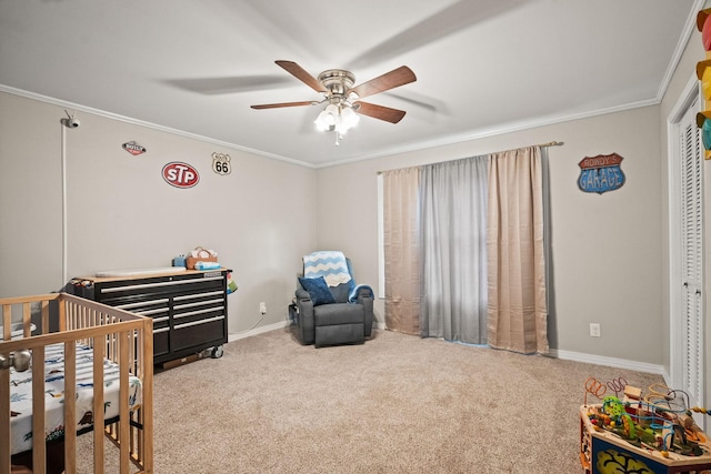 bedroom featuring a nursery area, ceiling fan, ornamental molding, and carpet