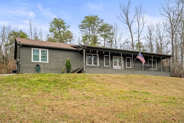 back of property featuring a lawn