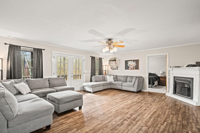 living room with french doors, ornamental molding, wood-type flooring, and ceiling fan