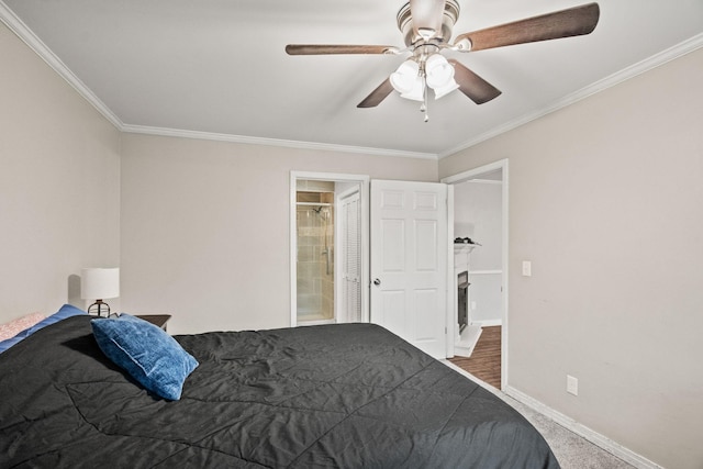 carpeted bedroom featuring ornamental molding, ensuite bathroom, and ceiling fan