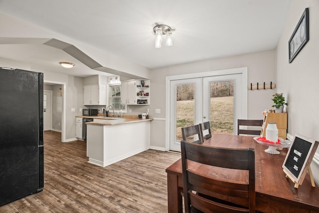 dining area with hardwood / wood-style flooring and french doors