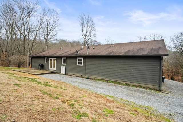 rear view of property featuring a yard and french doors