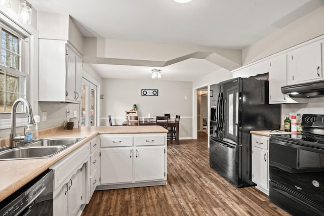 kitchen with sink, black appliances, dark hardwood / wood-style flooring, kitchen peninsula, and white cabinets