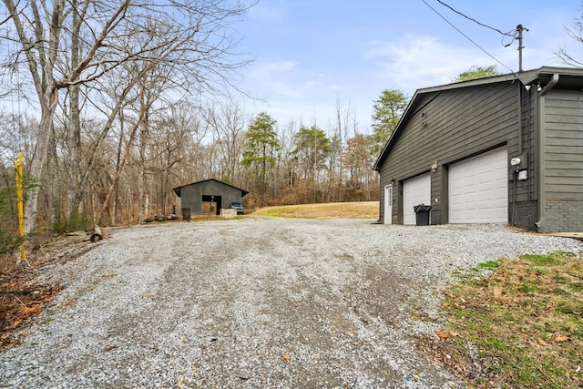 exterior space with a garage and an outdoor structure