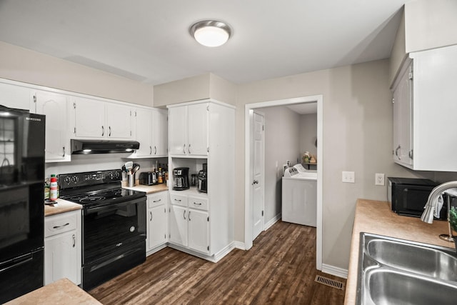 kitchen featuring dark hardwood / wood-style floors, sink, white cabinets, black appliances, and washing machine and dryer