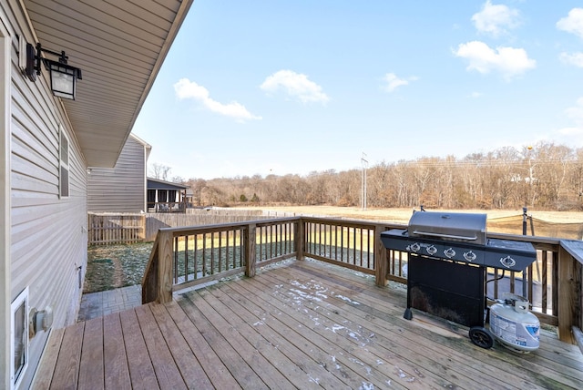 wooden deck featuring a grill