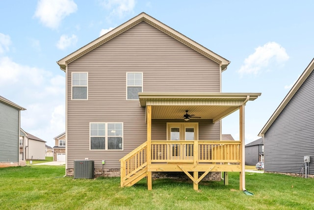 rear view of house featuring a wooden deck, a lawn, ceiling fan, and central air condition unit