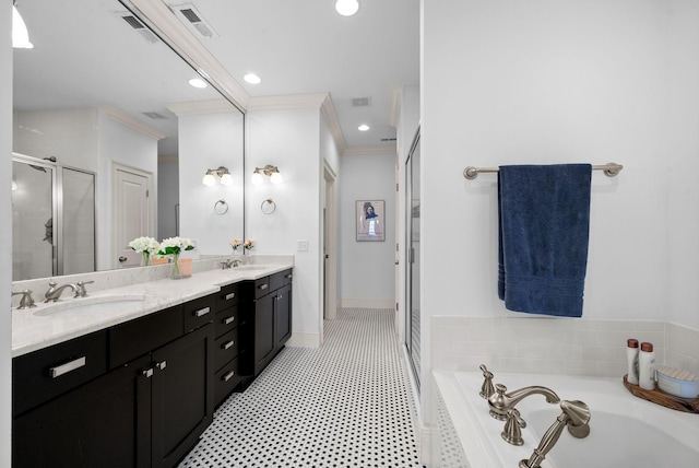 bathroom with vanity, crown molding, and shower with separate bathtub