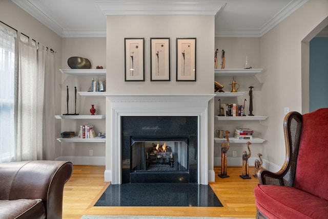 living room featuring ornamental molding, wood-type flooring, and built in features