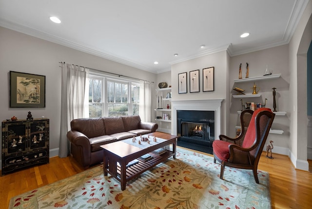 living room featuring ornamental molding and light wood-type flooring