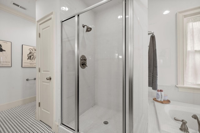 bathroom with crown molding and an enclosed shower