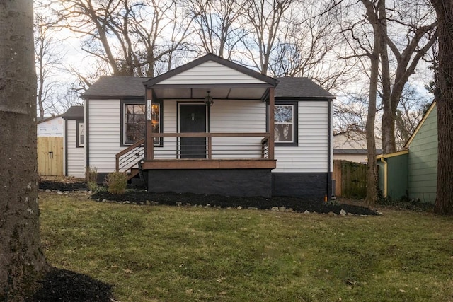 bungalow-style house featuring a front lawn and covered porch