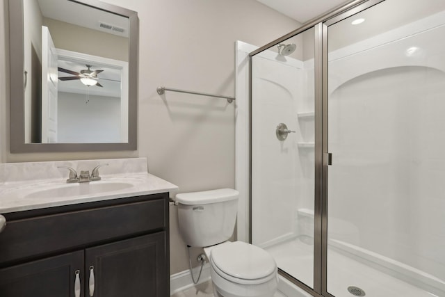 bathroom with ceiling fan, vanity, toilet, and an enclosed shower