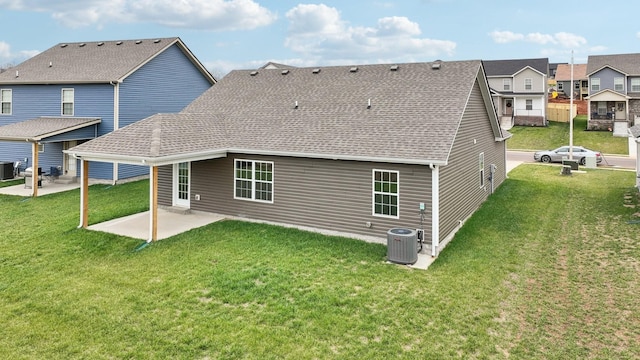 rear view of property featuring a patio, central AC unit, and a lawn