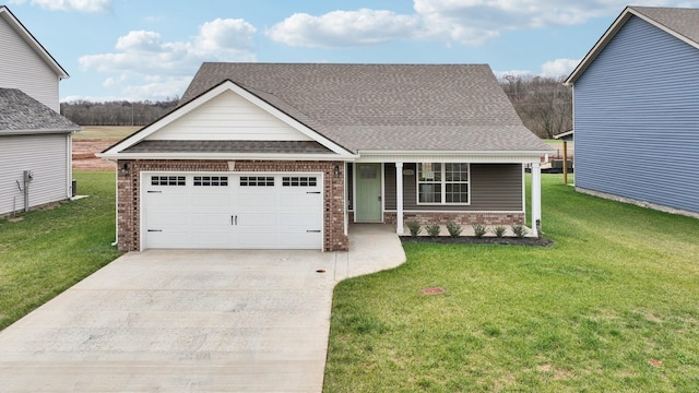 view of front of property featuring a garage, a front yard, and covered porch