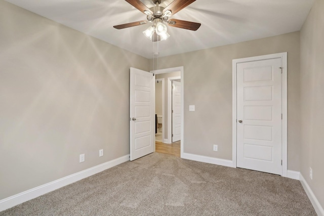 unfurnished bedroom with ceiling fan and carpet floors