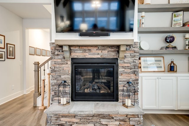 details with hardwood / wood-style floors and a fireplace