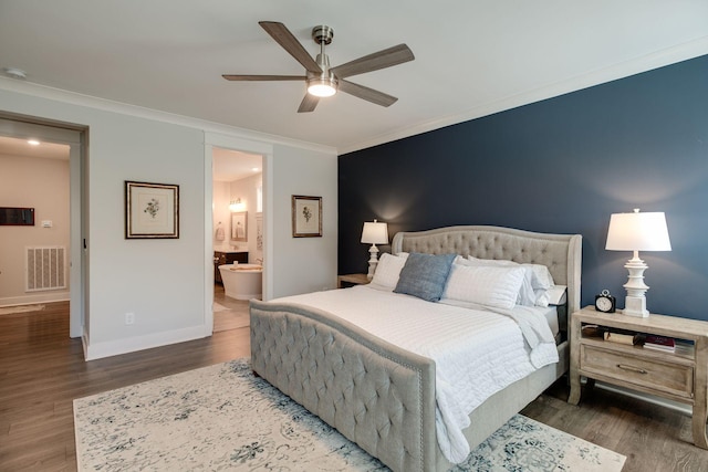 bedroom featuring dark hardwood / wood-style flooring, ornamental molding, ceiling fan, and ensuite bathroom