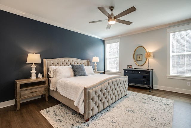 bedroom featuring crown molding, dark wood-type flooring, and ceiling fan