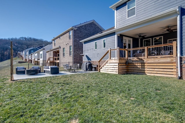 rear view of property with a lawn, ceiling fan, and a patio area