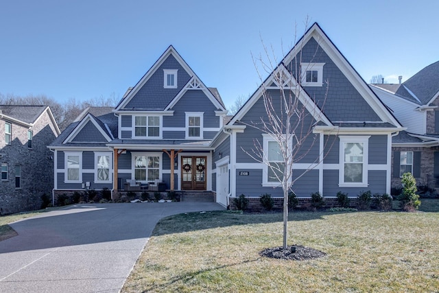 craftsman inspired home with a front lawn and french doors