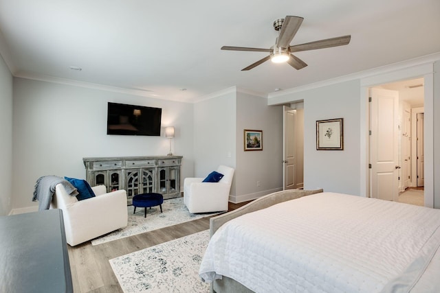 bedroom with ornamental molding, ceiling fan, and light hardwood / wood-style floors