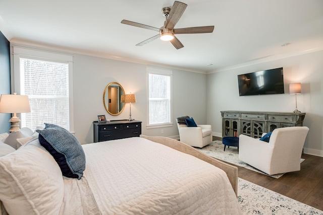 bedroom featuring ornamental molding, dark wood-type flooring, and ceiling fan