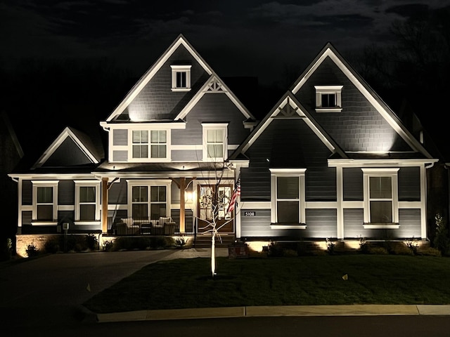 craftsman-style house with a porch and a lawn