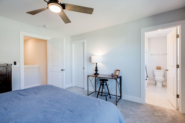 carpeted bedroom featuring connected bathroom and ceiling fan