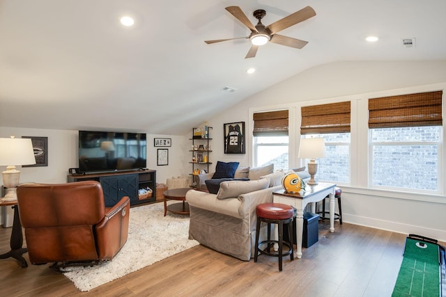 living room featuring ceiling fan, wood-type flooring, and vaulted ceiling