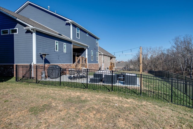 rear view of property with a patio and a lawn