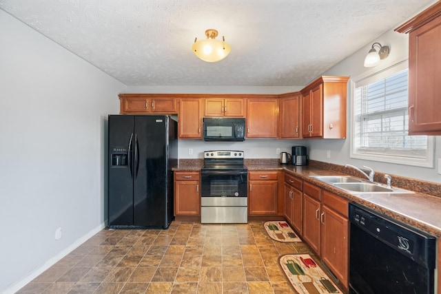 kitchen featuring sink, black appliances, and a textured ceiling