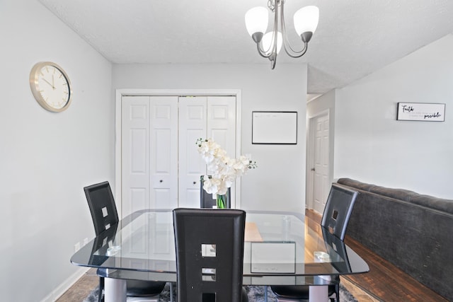 dining area with a notable chandelier and a textured ceiling