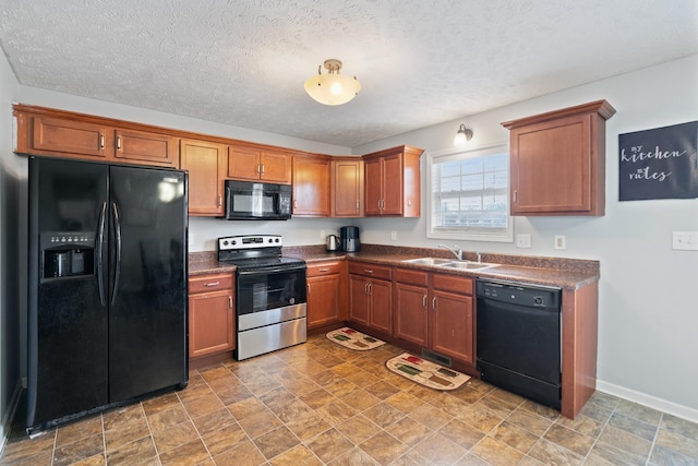 kitchen with sink, black appliances, and a textured ceiling