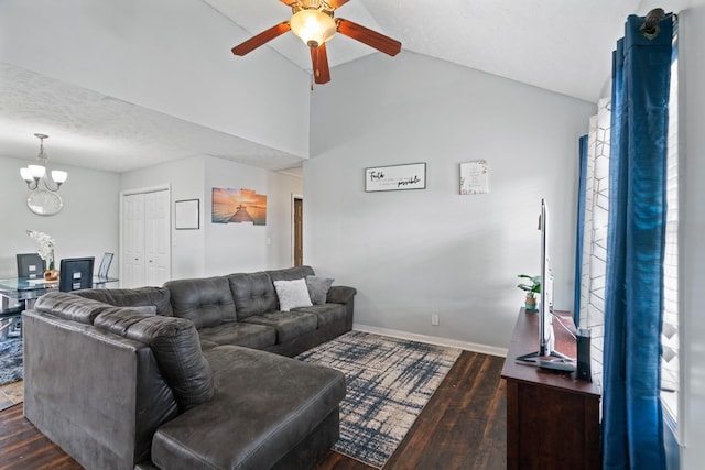 living room featuring dark wood-type flooring, lofted ceiling, ceiling fan with notable chandelier, and a textured ceiling