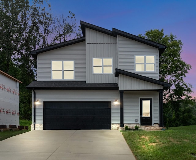 view of front of home featuring a garage and a yard