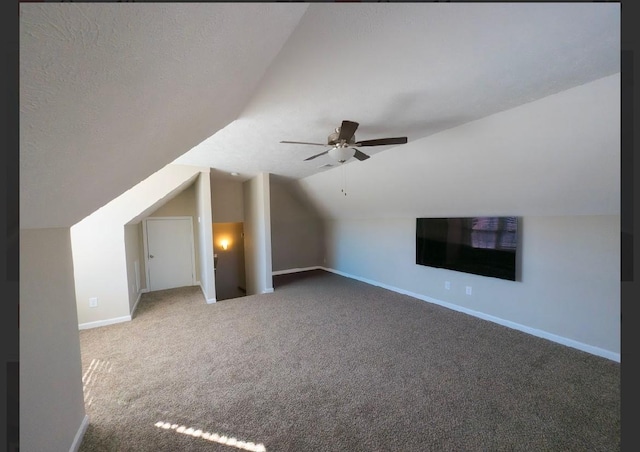 additional living space with lofted ceiling, ceiling fan, a textured ceiling, and carpet flooring