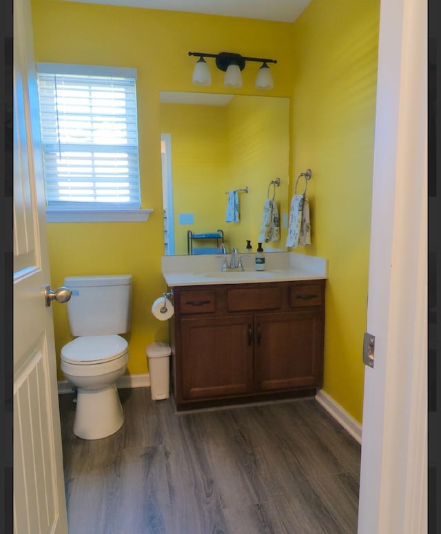 bathroom featuring hardwood / wood-style flooring, vanity, and toilet