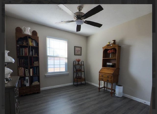 misc room with dark wood-type flooring and ceiling fan