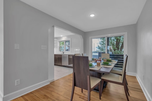 dining area featuring sink and light hardwood / wood-style floors