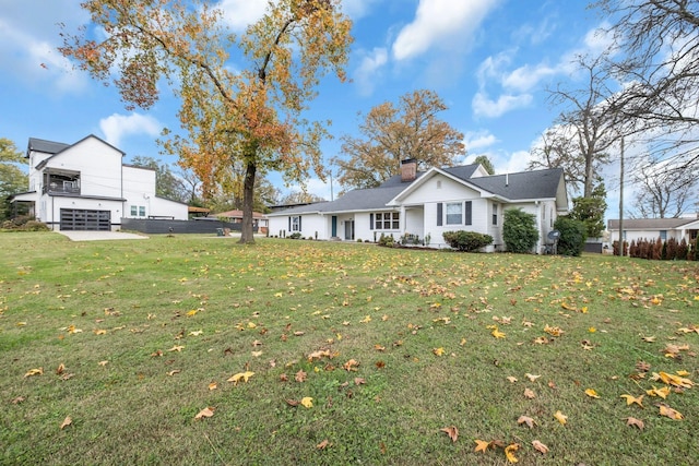 exterior space featuring a garage and a lawn