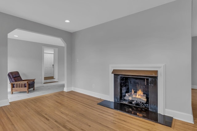 unfurnished living room featuring wood-type flooring