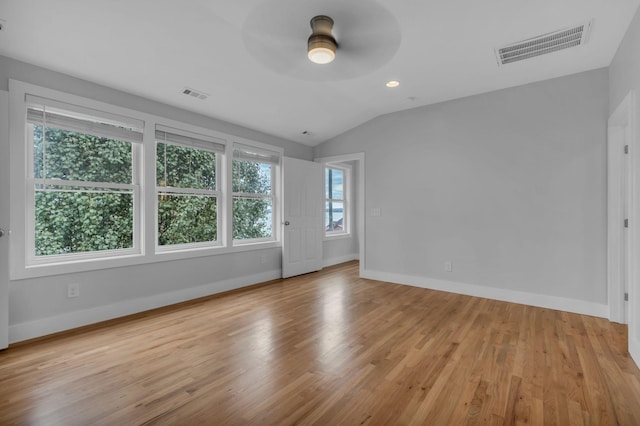 spare room featuring lofted ceiling, light hardwood / wood-style flooring, and ceiling fan