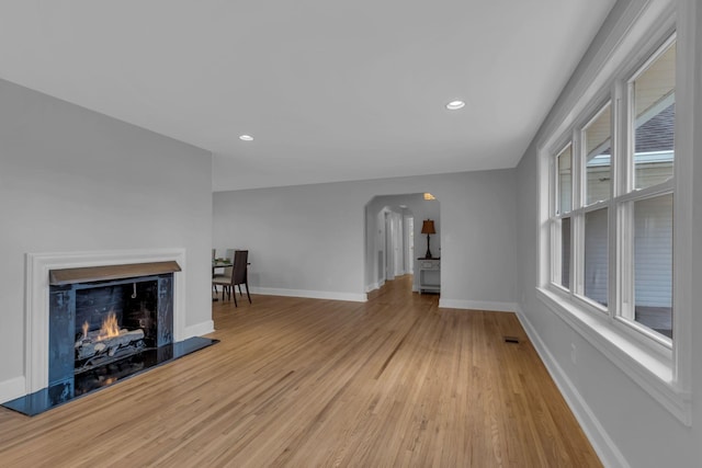 unfurnished living room with plenty of natural light and light hardwood / wood-style floors