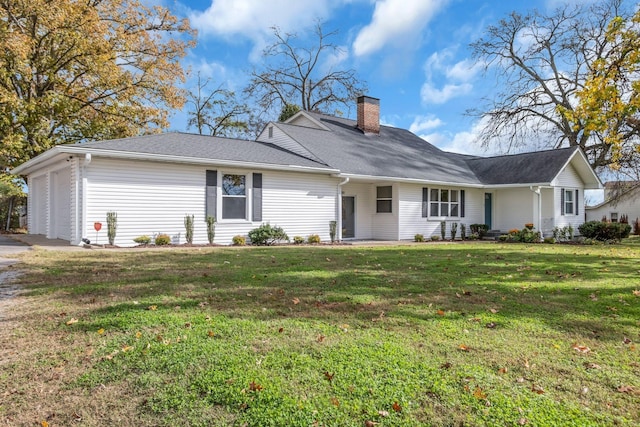 ranch-style home with a garage and a front lawn