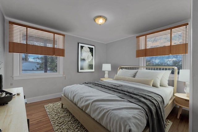 bedroom featuring crown molding and dark hardwood / wood-style flooring