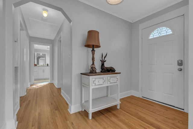 entrance foyer with crown molding and light wood-type flooring